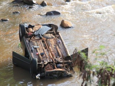 Carro caiu no crrego e ficou com as quatro rodas para cima (Foto: Marina Pacheco)