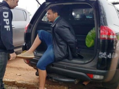 Momento em que bandido brasileiro era colocado em viatura da PF em Pedro Juan Caballero (Foto: Mbykymi Notícias)