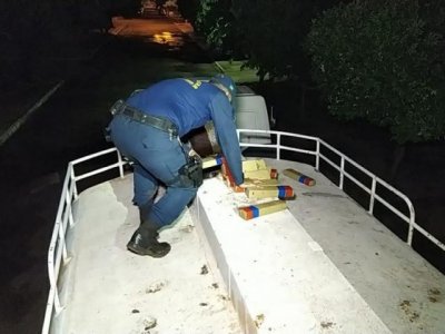 Policial retira os tabletes de maconha (Foto: Adilson Domingos)